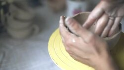 Hands working on pottery wheel shaping ceramics Stock Footage