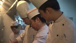 Chefs stand next to each other as they cook in a restaurant kitchen. Stock Footage
