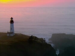AERIAL Lighthouse at Pacific coast at sunset, Oregon, USA Stock Footage