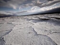 WS LA POV Shot of Dry Cracked Earth and Salt Flats / Death Valley NP, California, United States  Stock Footage