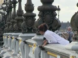 MS Woman standing on bridge and taking picture / Paris, Ile-de-France, France    Stock Footage