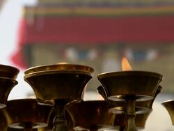 CU R/F Shot of yak-butter lamps at Boudhanath Stupa temple / Kathmandu, Nepal Stock Footage