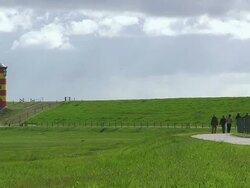 WS People walking at Pilsum lighthouse near Krummhorn at North Sea (Eastern Friesland) / Lower Saxony Stock Footage