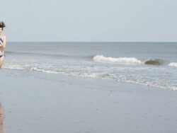  WS SLO MO  Man with squirt gun chasing woman on the beach / Isle of Palms, South Carolina, USA Stock Footage