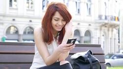 Happy girl text messaging Stock Footage