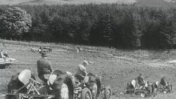 1942 MONTAGE Farmers working and fertilizing fields using shared mechanized equipment / United Kingdom Stock Footage