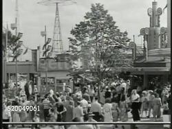 1946: PALISADES PARK: HA WS People walking in amusement park, rides BG. Strongman using mallet to measure strength. Instructional Video