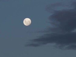 Moon against clouds at dusk Stock Footage