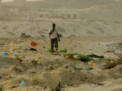 WS, Man walking on beach covered with trash, Nouadhibou, Mauritania Stock Footage