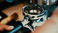 Making Ground Coffee with Coffee Grinder. Close-Up. Stock Footage