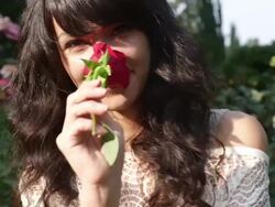 CU SLO MO TS Shot of beautiful brunette walks with rose, smiling playfully / Portland, Oregon, United States  Stock Footage