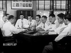 1947: STANDARD OIL (INDIANA): SALES: 'Sales Manager Reseller' sign. Salesmen meeting around large desk. Salesman 'George Berger' talking to male at desk, no SOT. Instructional Video