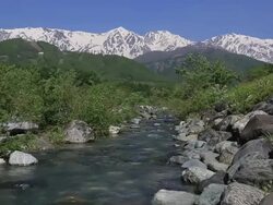WS View of Hida Mountains, Northern Alps and melted snow melted snow river / Hakuba, Nagano Prefecture, Japan  Stock Footage