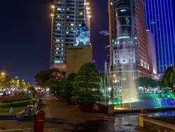 MS T/L Shot of water fountain in front of Renaissance Riverside Hotel at night / Ho Chi Minh City, Southeastern, Vietnam Stock Footage