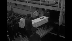 Men load coffins of 1952 Oshima Island plane crash victims onto boat as families watch News Clip