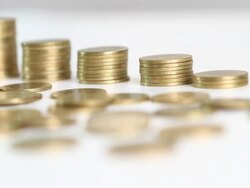Dolly: Savings, increasing columns of gold coins. Stock Footage