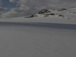 Aerial of Norwegian mounatins and glacier in winter. Stock Footage