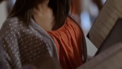 Woman points out favorite menu items to man in gourmet restaurant Stock Footage