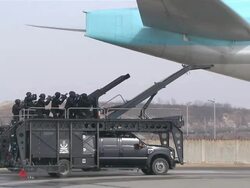 MS ZO TS Police commando doing simulation exercise against terrorism on runway of Incheon International Airport / Incheon, South Korea Stock Footage