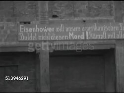 1953: EAST BERLIN, GERMANY: HANDHELD: SLIGHTLY SHAKY MS Various signs in East Berlin, in German, calling for United States President Dwight D. Eisenhower to free Nazi Alfred Rosenberg. Instructional Video