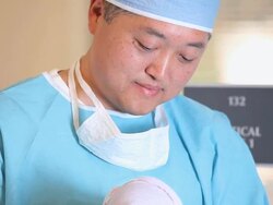 CU TU Doctor in Surgical Scrubs Holding Newborn Baby in Hospital / Richmond, Virginia, USA Stock Footage