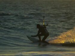 Telephoto shot of kitesurfer's maneuver in nice sunset colors Stock Footage