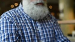 Adult senior bearded man sitting with a laptop Stock Footage
