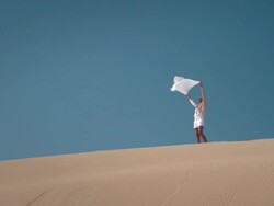 Woman with scarf in desert Stock Footage