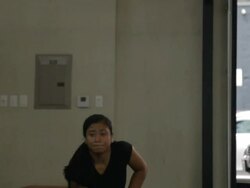 Medium shot. Jonice performs series of dumbell snatches. Stock Footage