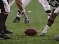 SLO MO, CU, American football players tackling on field in rain, Staten Island, New York, USA Stock Footage