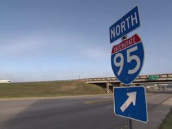 Interstate Road Sign And Passing Vehicles News Clip