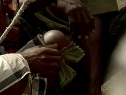 Ethiopan men counting money at camel market Stock Footage