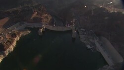 The sun shines over the Colorado River and Hoover Dam. Stock Footage
