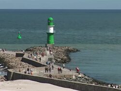 WS View of Lighthouse at WarnemÃƒÂ¼nde beach in front of Baltic Sea / WarnemÃƒÂ¼nde, Mecklenburg-Western Pomerania, Germany Stock Footage