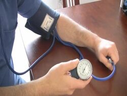 man checking his blood pressure sphygmomanometer ntsc Stock Footage