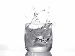 Two Pills falling into a Glass of Water against white background, Slow motion Stock Footage