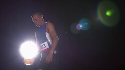 A track athlete spins around and throws a discus through the air. Stock Footage