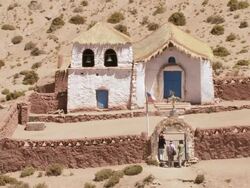 MS Shot of Country church at Machucca in high Andes and tourist looking at it / San Pedro de Atacama, Norte Grande, Chile Stock Footage