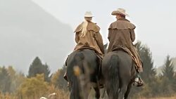 DS Cowgirl holding hands with cowboy on horseback ride Stock Footage