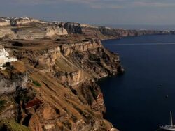 Panning across the bay to the white washed houses of Thira overlooking the Aegean Sea on the Island of Santorini, Greece, Europe Stock Footage