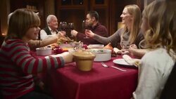 Family making a toast with raised glasses at Thanksgiving table Stock Footage