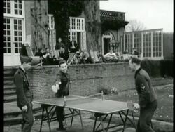 Wounded German soldiers rehabilitate in a manor. The soldiers play table tennis, a cards game and maintain the garden   Stock Footage