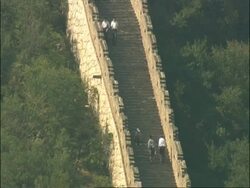 Tourists walking up flight of stairs on Great Wall of China, Mutianyu, China Stock Footage