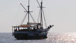 Fishing trawler sails into open sea Stock Footage
