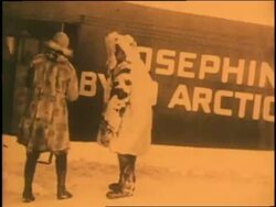 Admiral Richard E. Byrd shakes hands with other men in front of his Josephine Ford Fokker Trimotor airplane. News Clip