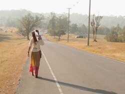Hippie woman walking on the road Stock Footage
