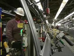 MS Woman preparing door for installation on minivan in an auto assembly plant / Princeton, Indiana, United States Stock Footage