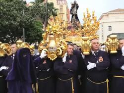 Golden Trono a religious float being carried by the Costaleros during Semana Santa, a procession through the streets of Malaga, Spain, Europe Stock Footage