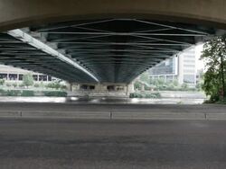 WS Two young girls running and exercising together in urban setting near bridge and river / Minneapolis, Minnesota, United States Stock Footage