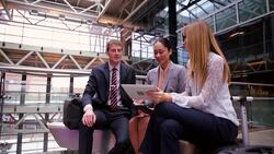 Business people using digital tablet on atrium balcony Stock Footage